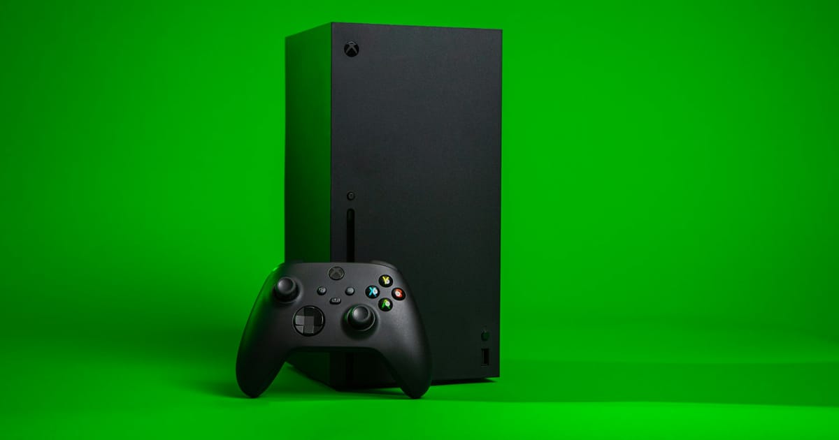 Una consola Xbox negra con su control, vista de cerca.